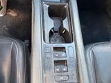 a close up of a car ' s center console with a flower in it