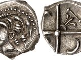 a close up of a silver coin with a face on it