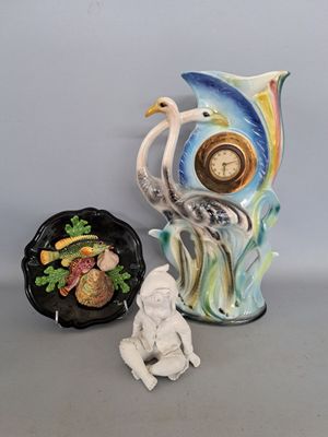 two vases and a figurine sitting next to each other