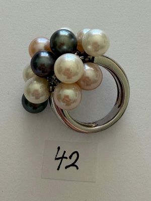 a ring with a bunch of different colored pearls on it