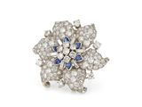a close up of a diamond and sapphire flower ring