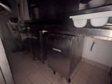 an image of a kitchen with a lot of dishes on the counter