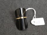 a black ring with a gold band and a price tag