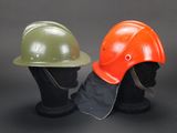 two helmets are sitting next to each other on a mannequin head