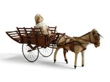 a toy horse pulling a carriage with a woman in it