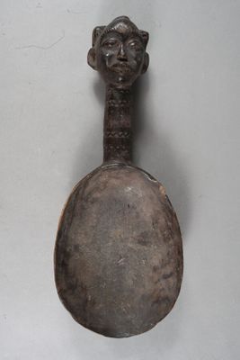 a spoon with a face on it and a spoon with a face on it