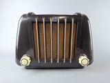 an old black toaster sitting on top of a white table