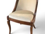 a close up of a wooden chair with a beige upholstered seat