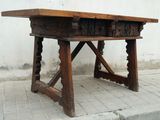 a wooden table with carvings on the top of it