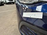 cars parked in a parking lot with a sticker on the front of the car