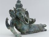 statue of an elephant with a seated head on its back