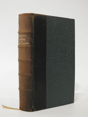 an old book sitting on top of a table next to a white wall