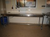 an image of a kitchen with a table and a trash can