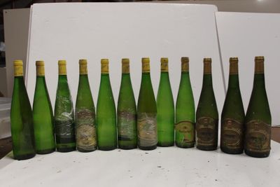 bottles of wine are lined up in a row on a table