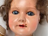 a close up of a doll with a broken arm