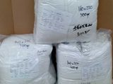 several bags of white yarn sitting on top of a cardboard box