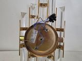 a clock that is made out of glass and gold