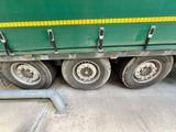 a green semi truck that is parked on the side of the road
