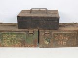 two old metal boxes sitting on top of each other on a table