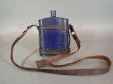 a small blue bottle with a brown strap on it