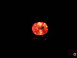 an orange diamond in the dark with a black background