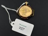 a close up of a tag and a watch on a black surface