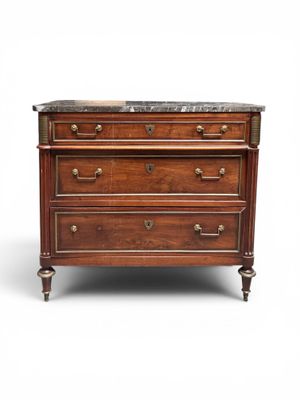 an antique chest of drawers with marble top