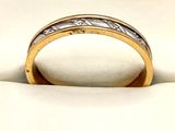 a close up of a wedding ring with a diamond in it