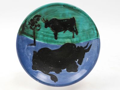 a plate with a picture of a bull and a cow on it