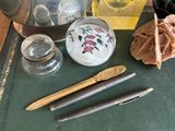 a tea pot, a teapot, a glass jar, and a pen on a table