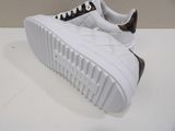 white sneakers with leopard print on the soles on a white surface
