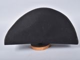 an image of a black hat on a wooden stand