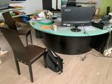 a desk with a chair and a computer on it
