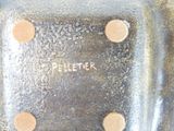 a close up of a piece of metal with holes on it