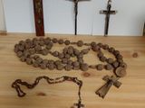 a wooden table with a rosary and a cross on it