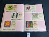 a pink book with stamps on it on a table