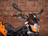 a motorcycle that is parked in front of a brick wall