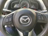 the steering wheel of a car with a mazda logo on it