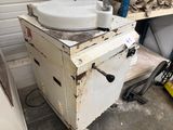 a white sink sitting on top of a white cabinet