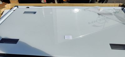 a white refrigerator sitting on top of a wooden table