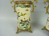 two vases that are decorated with birds and flowers