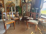 four chairs that are sitting in the middle of a room