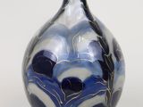 a blue and white vase sitting on a white surface