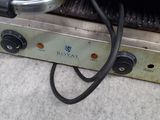 an image of a close up of a grill with a cord attached to it