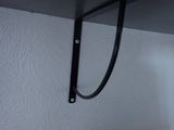 a black shelf with a black handle on it