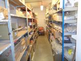 a long narrow aisle with lots of boxes and boxes on the shelves