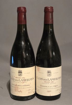 two bottles of wine sitting on top of a table next to each other