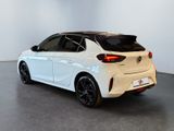 the rear end of a white toyota corollant parked in a white room