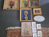 a lot of framed pictures on the floor next to a mirror
