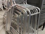 many chairs that are stacked on top of each other